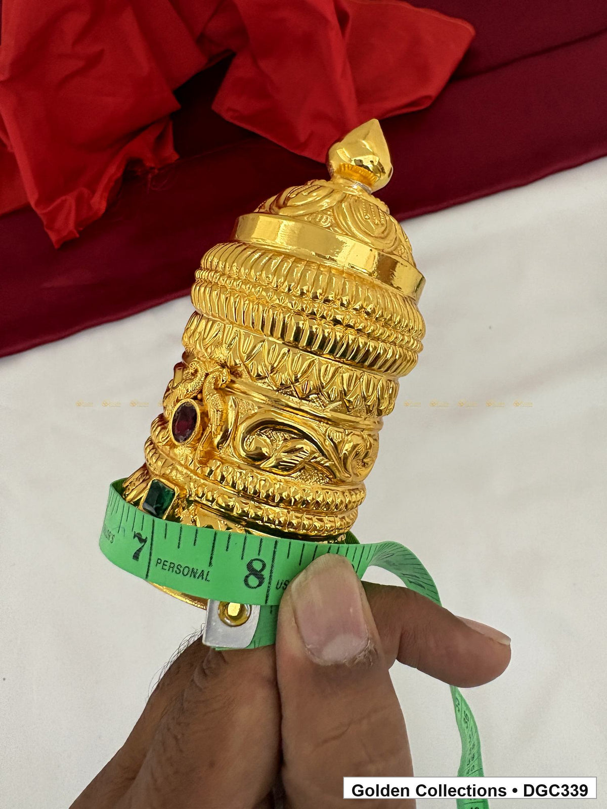 Height measurement view of scroll medallion full-round brass deity crown with red green accents, measured size 4.7 X 7.5 X 2.25