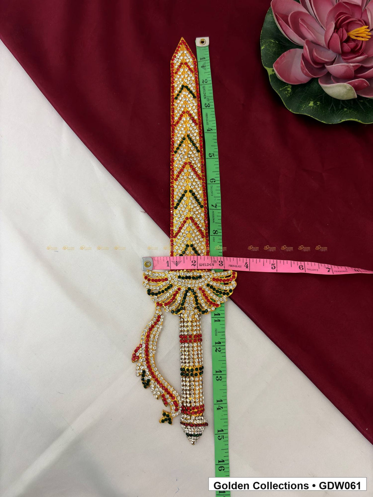 Stone-studded deity sword with a tape beside its length and another across the guard showing measurement placement.