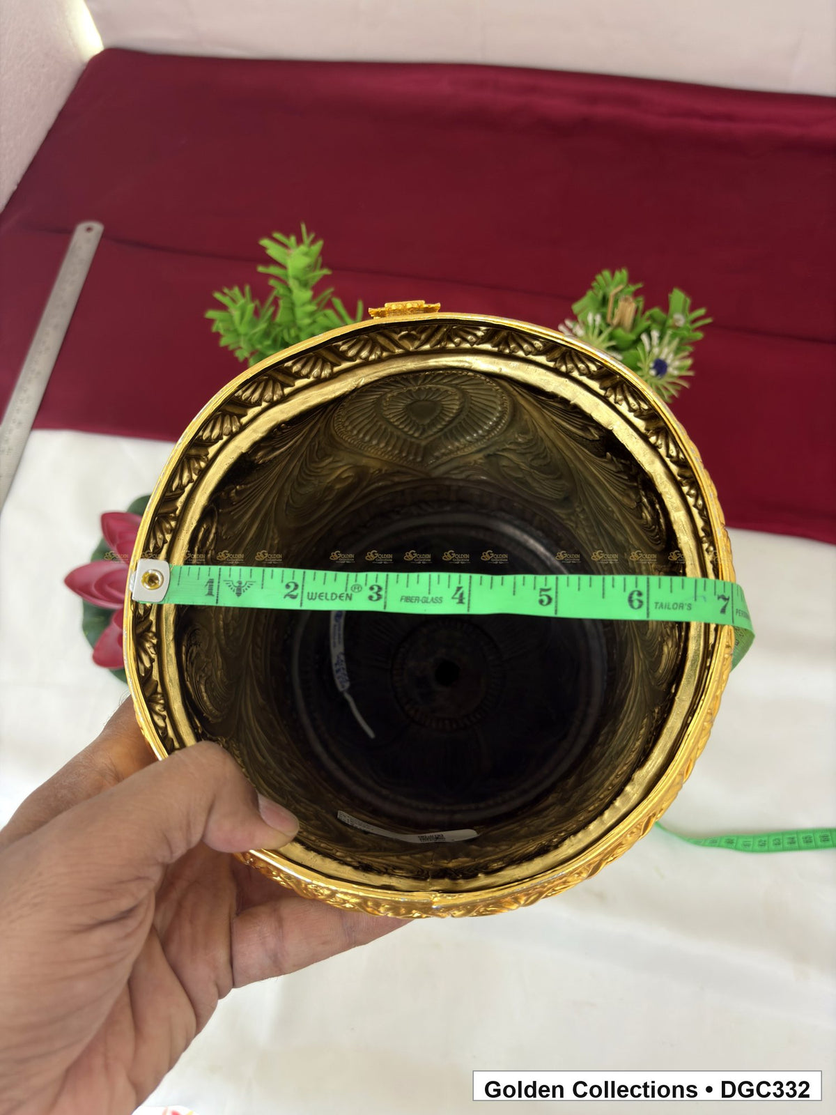 Opening measurement view of teardrop medallion full-round brass deity crown with red green accents, measured size 15 X 23 X 7