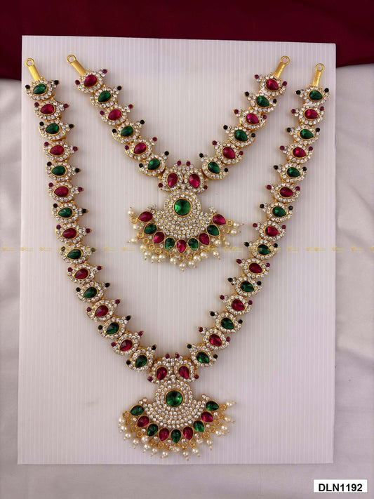 Front view of deity long haram set with multicolor stones and gold plating for idol alankaram