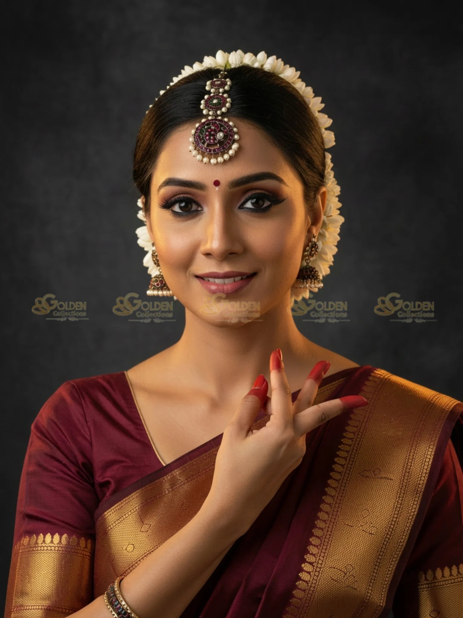 Golden Collections Black Kemp Maang Tikka - Model in traditional saree, bindi, & flower adornments for Bharatanatyam.