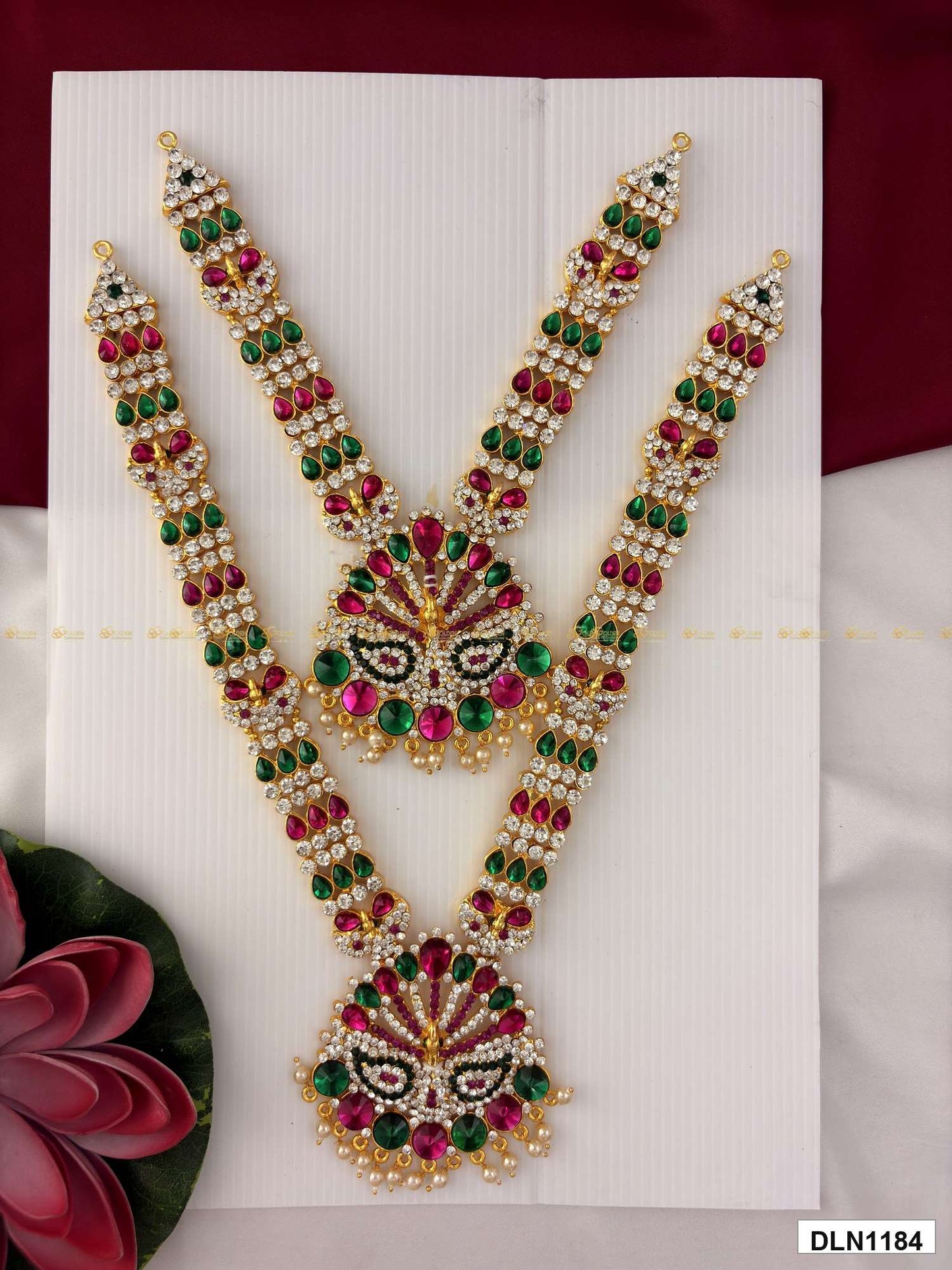 Front view of deity long haram set with multicolor stones and gold plating for idol alankaram