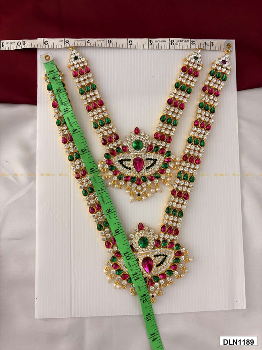 Front view of deity long haram set with multicolor stones and gold plating for idol alankaram