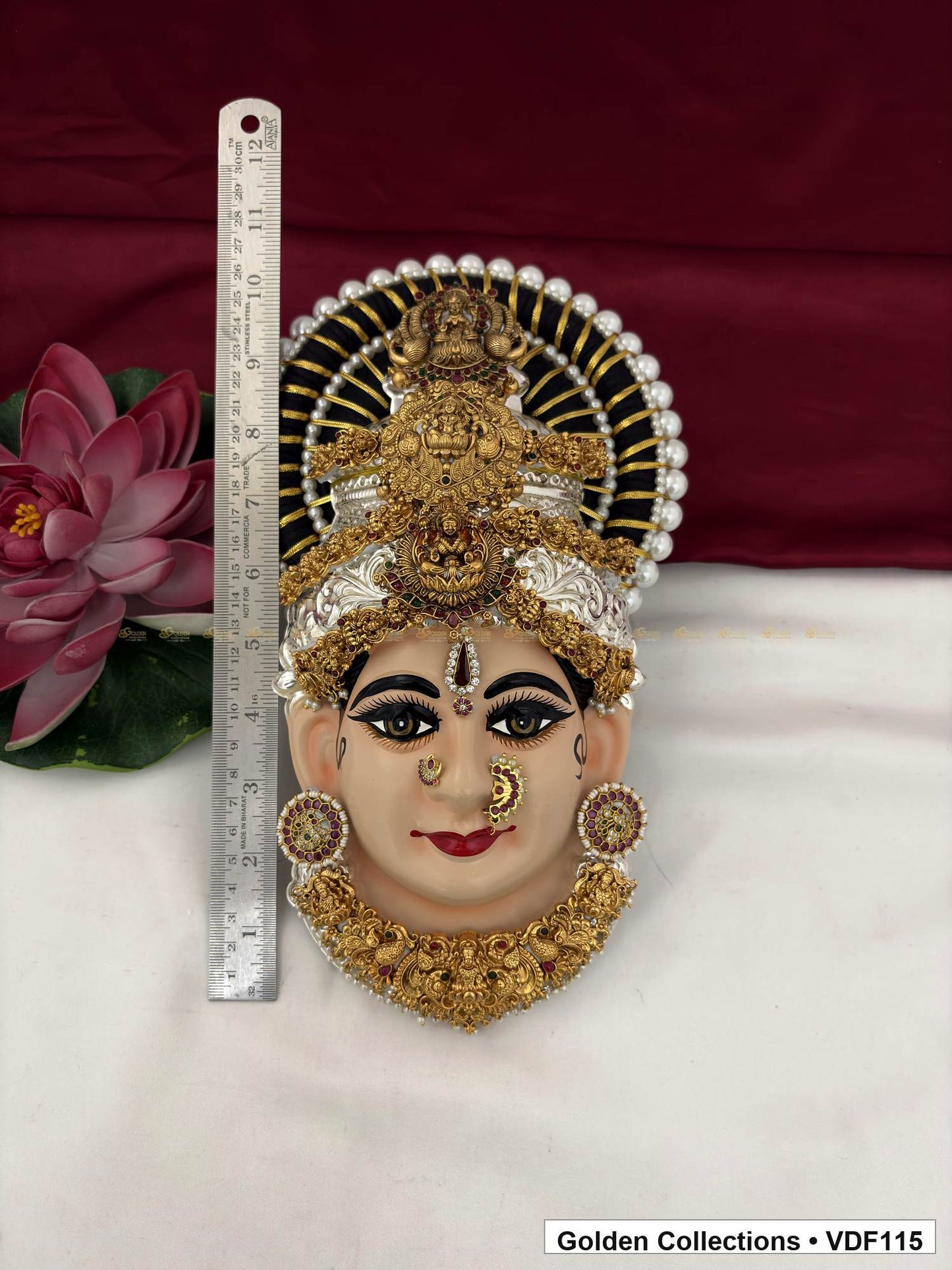 Measurement view of Varalakshmi Tanjore Face with Layered Deity Crown and Ornate Pendant Necklace with ruler beside the product