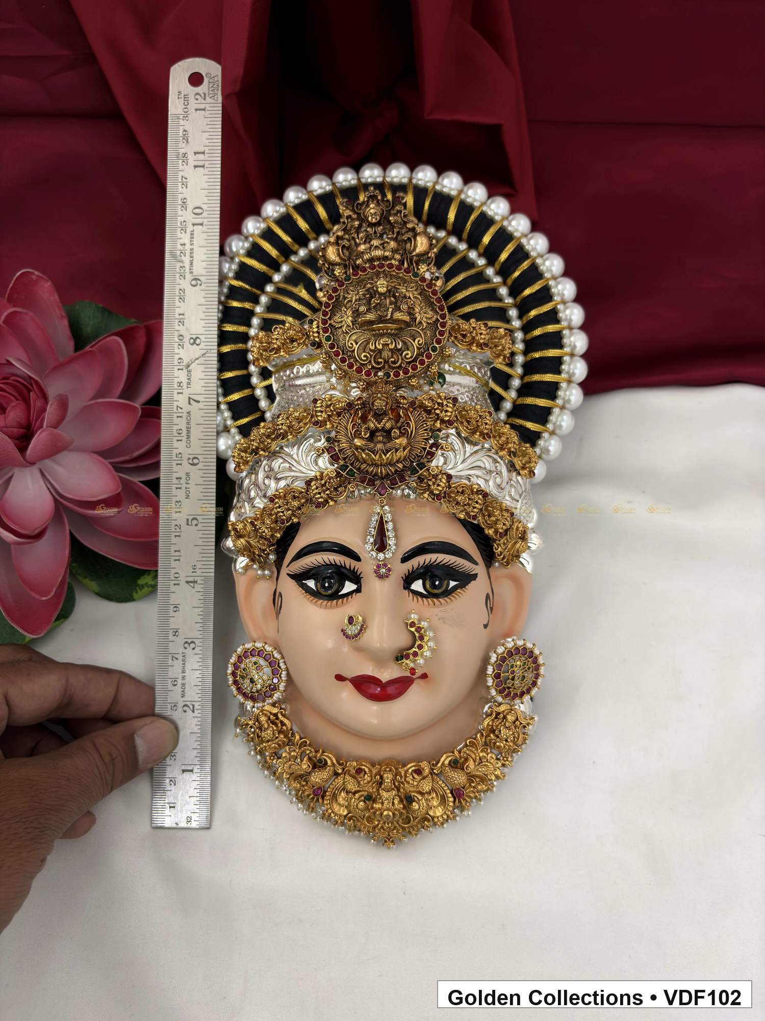 Varalakshmi Tanjore Face with Round Medallion Crown and Green Fringe Necklace close-up detail view