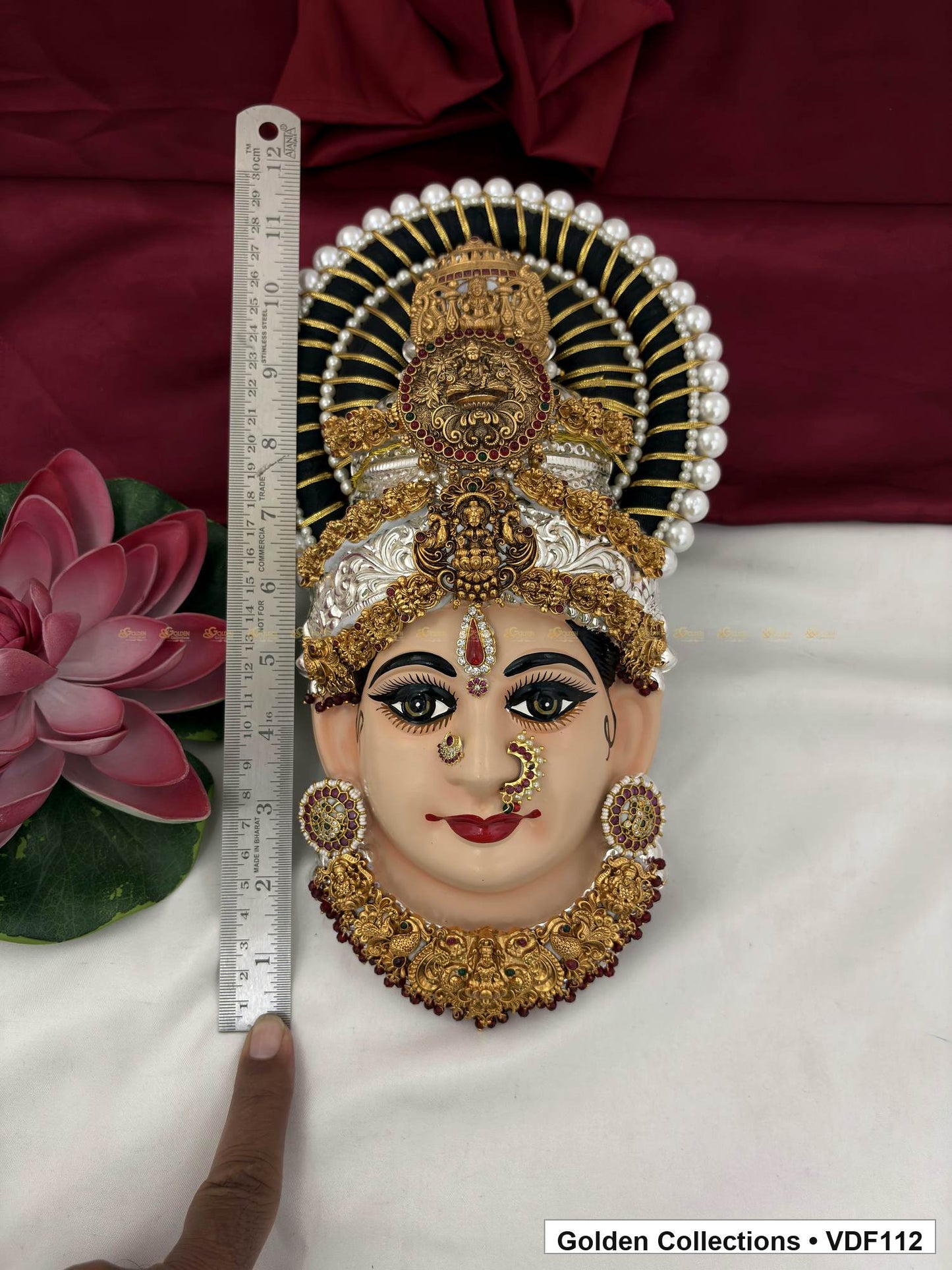 Measurement view of Varalakshmi Tanjore Face with Stacked Medallion Crown and Broad Sculpted Necklace with ruler beside the product
