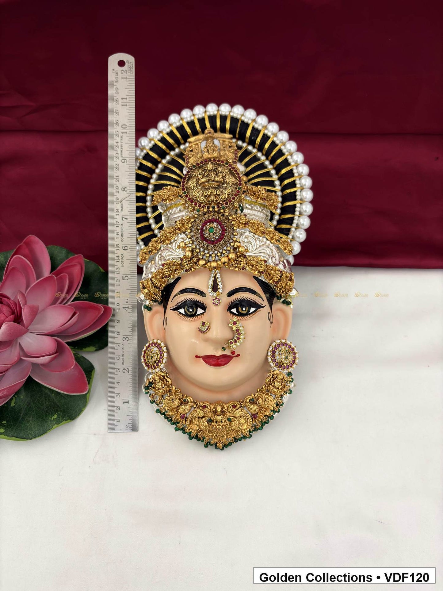 Measurement view of Varalakshmi Tanjore Face with Teardrop Medallion Crown and Broad Floral Necklace with ruler beside the product